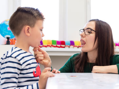 Speech Therapist teaching a kid