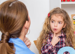 Speech therapist teaching a child